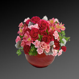 Pink and red rose bouquet in a red vase
