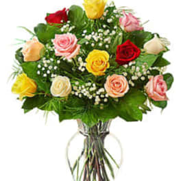 Bouquet of multicolored roses in a clear glass vase