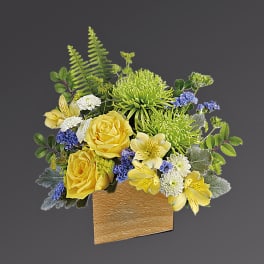 Yellow roses and green chrysanthemums in a gold vase