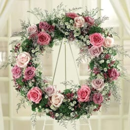 Pink and white rose wreath on a stand