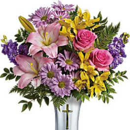 Mixed bouquet of pink, purple, and yellow flowers in a silver vase