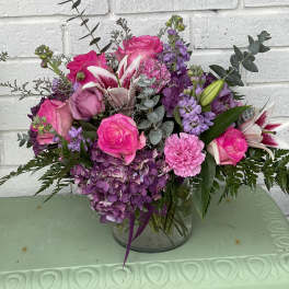 Pink and purple bouquet in a clear glass vase