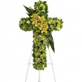Green floral cross on a stand with yellow orchids