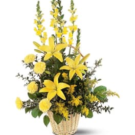 Yellow lilies and carnations in a wicker basket