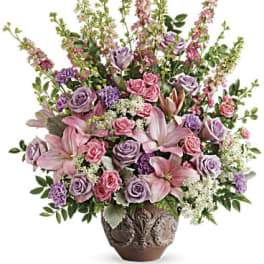 Pink and lavender floral arrangement in a decorative vase