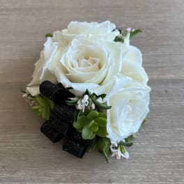 White rose bouquet with succulents and a black ribbon
