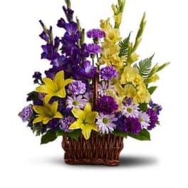 Basket arrangement of purple and yellow flowers