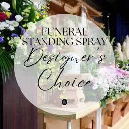 Funeral standing spray with white, purple, and yellow flowers