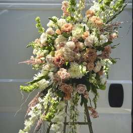 Large peach and white floral spray on an easel