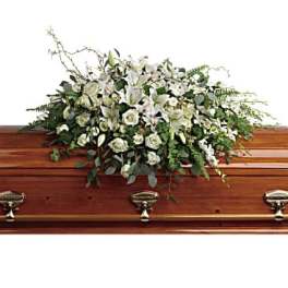 White floral casket spray with lilies and roses