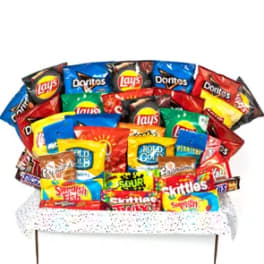 Assorted snack bags arranged like a bouquet on a bench