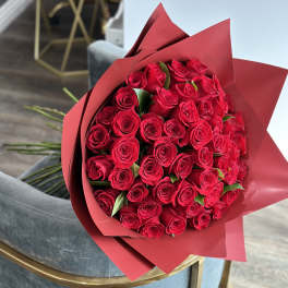 Bouquet of red roses wrapped in red paper