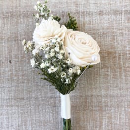 White rose boutonniere with baby's breath and greenery