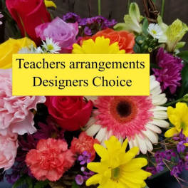 Colorful mixed flower arrangement with a yellow sign reading Teachers arrangements Designers Choice