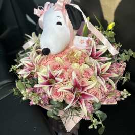 Pink rose bouquet with lilies and a Snoopy plush topper
