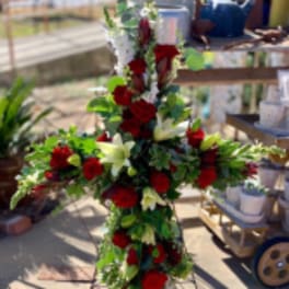 Tall floral cross with red roses and white lilies