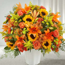 Orange and yellow mixed bouquet in a white vase