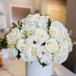 White rose and hydrangea bouquet in a white vase