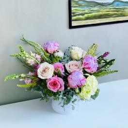 Pink and white roses with hydrangea in a white vase