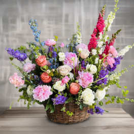 Colorful mixed flower arrangement in a wicker basket
