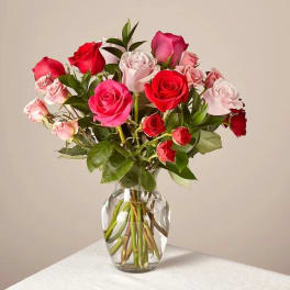 Bouquet of pink and red roses in a clear glass vase
