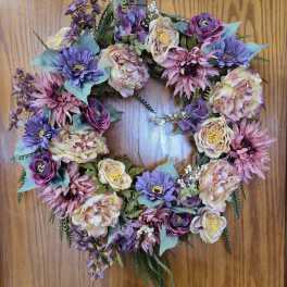 Heart-shaped floral wreath with pink, purple, and cream blooms