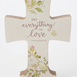 Decorative cross plaque with floral print and the words "do everything in love"