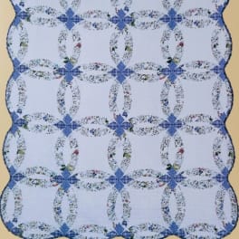 Blue and white quilt with floral ring patterns