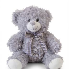 Lavender plush teddy bear with a plaid ribbon bow