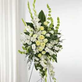 Tall white and pale green floral standing spray on an easel