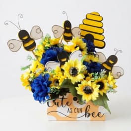 Sunflower arrangement with bee decorations in a printed box