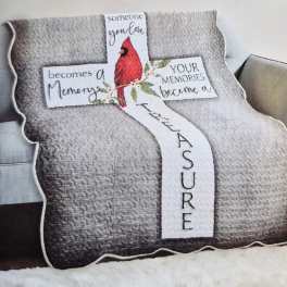 Quilted memorial pillow shaped like a cross with a red cardinal and text.
