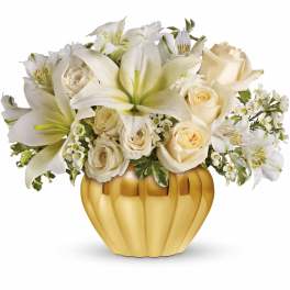 White lilies and cream roses in a gold pumpkin vase