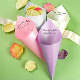 Pastel paper cones holding rose petals on a green background