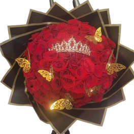 Bouquet of red roses with a jeweled tiara and gold butterfly accents