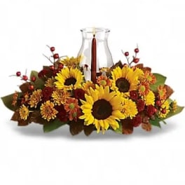 Sunflower and autumn flower arrangement in a clear glass vase