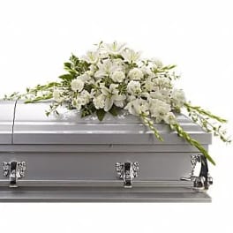 White floral spray on a silver casket