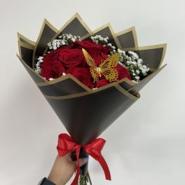 Bouquet of red roses with white baby's breath in black wrapping