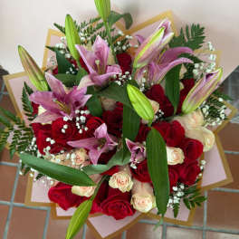Bouquet of red and cream roses with pink lilies