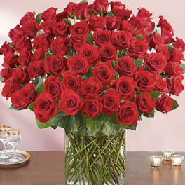 Large bouquet of red roses in a clear glass vase