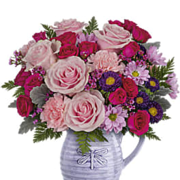 Pink and magenta mixed bouquet in a lavender pitcher vase