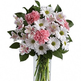 Pink carnations and white daisies in a clear glass vase