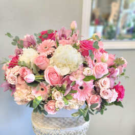 Pink and white mixed bouquet in a white container