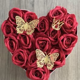 Heart-shaped box of red roses with gold butterfly accents