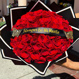 Large bouquet of red roses with a black ribbon banner
