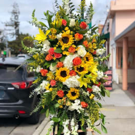 Yellow, orange & white sympathy spray.