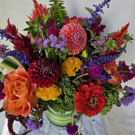 Colorful mixed bouquet in a striped green vase