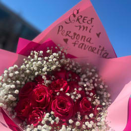 Bouquet of red roses with white baby's breath in pink wrapping