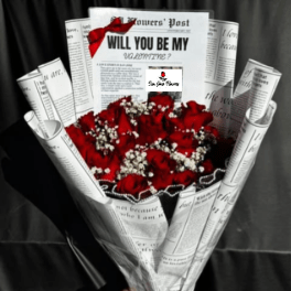 Bouquet of red roses wrapped in newspaper with a red ribbon