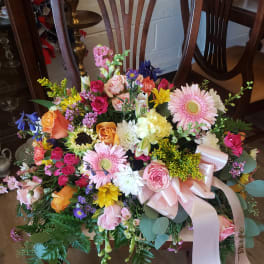 Large mixed bouquet with pink roses, gerbera daisies, and a pale ribbon